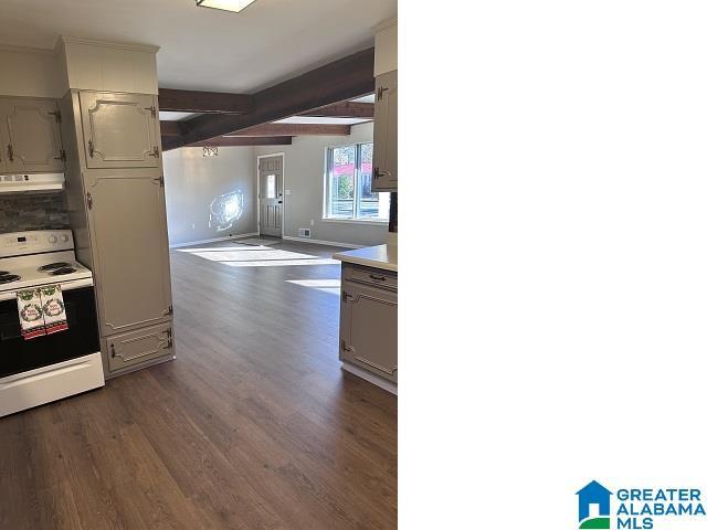 kitchen with beam ceiling, electric stove, extractor fan, and dark hardwood / wood-style floors