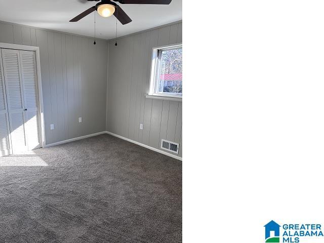 carpeted empty room with ceiling fan