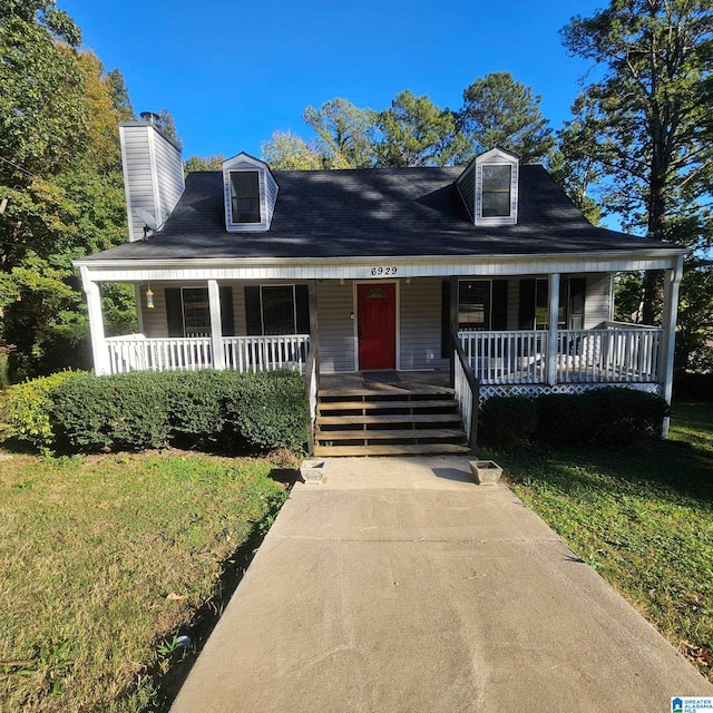 view of front of home with a porch and a front yard