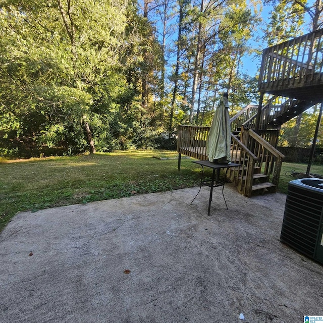 view of patio / terrace featuring a wooden deck and central AC