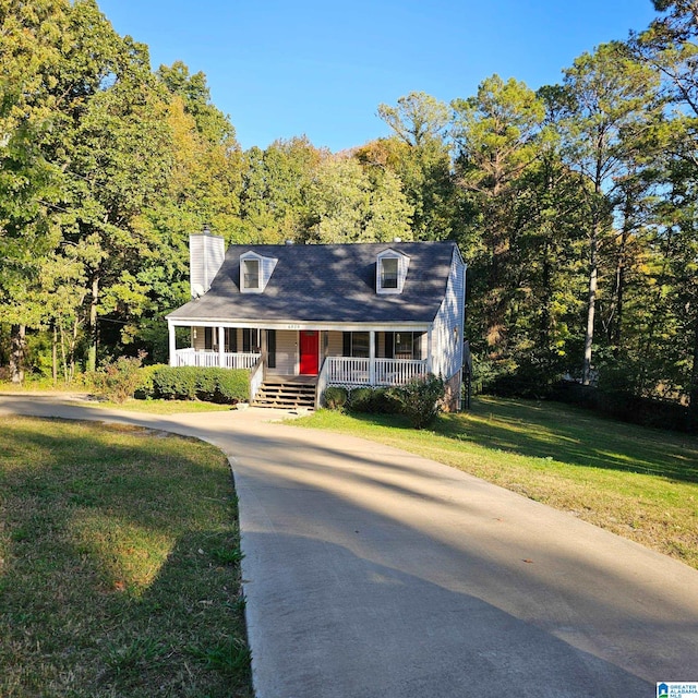 cape cod-style house with covered porch and a front yard