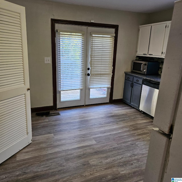 kitchen with white cabinetry, french doors, dark hardwood / wood-style floors, and appliances with stainless steel finishes