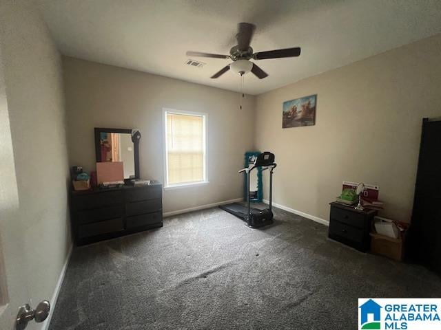 exercise room with ceiling fan and dark colored carpet