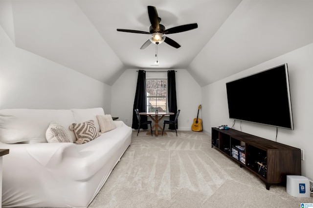 carpeted living room featuring ceiling fan and vaulted ceiling