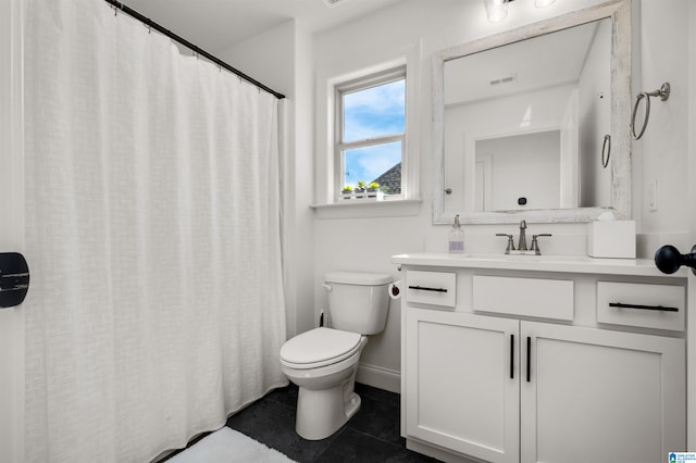 bathroom featuring tile patterned flooring, vanity, and toilet