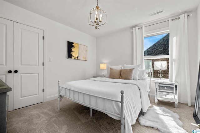 bedroom featuring carpet, a closet, and a chandelier