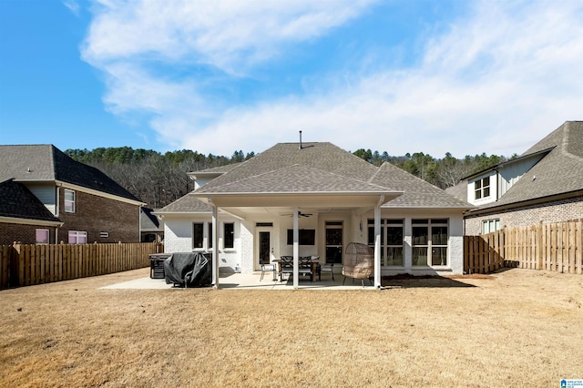 back of property featuring ceiling fan, a yard, and a patio