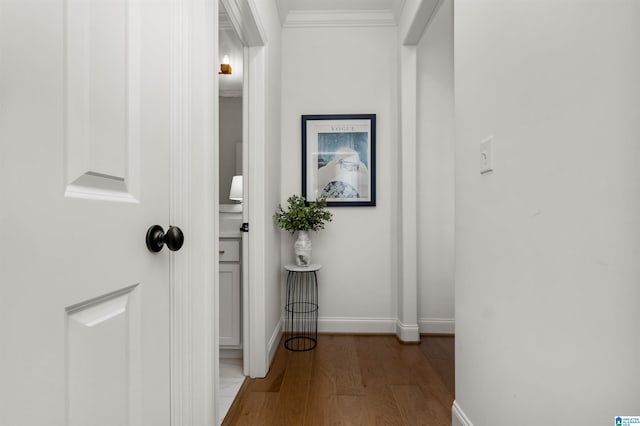 corridor with hardwood / wood-style flooring and crown molding