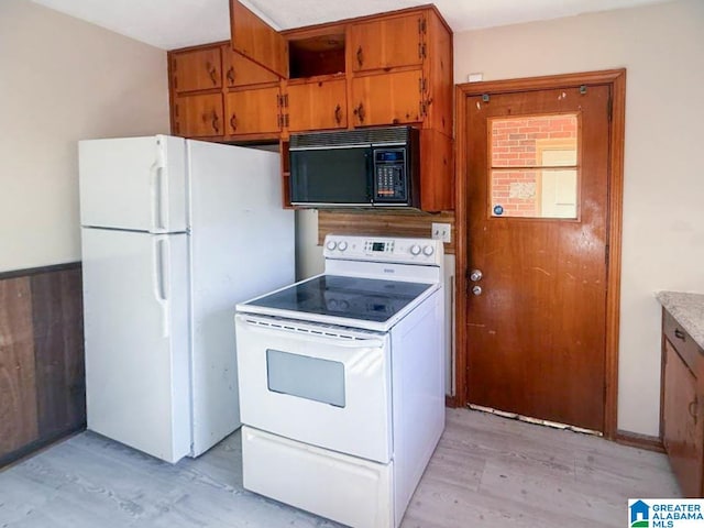 kitchen featuring light hardwood / wood-style flooring and white appliances