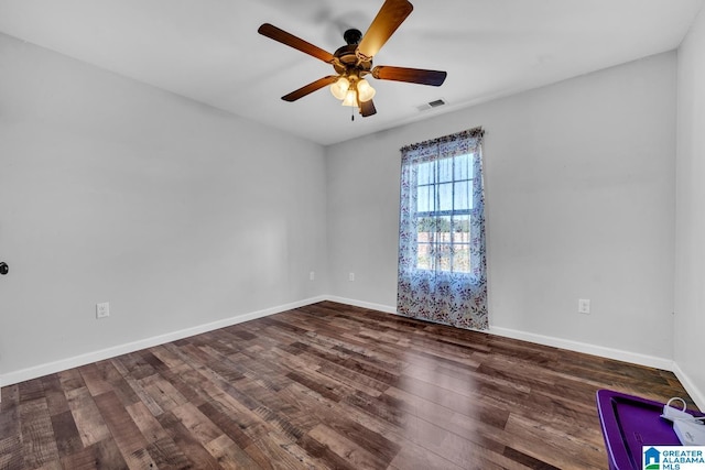 empty room featuring ceiling fan and dark hardwood / wood-style flooring