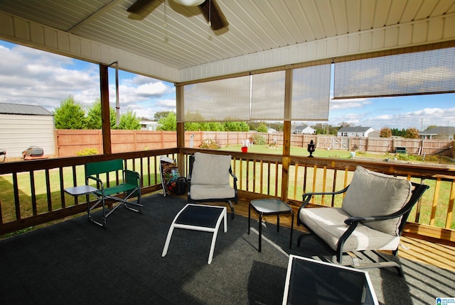 sunroom with a wealth of natural light and ceiling fan