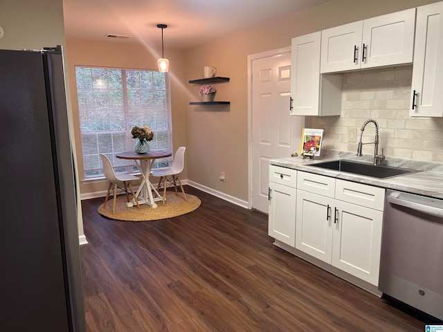 kitchen with pendant lighting, white cabinetry, sink, and stainless steel appliances