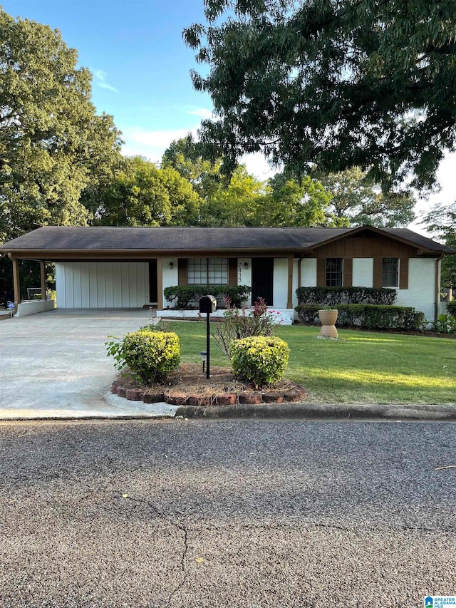 ranch-style home featuring a front yard and a carport