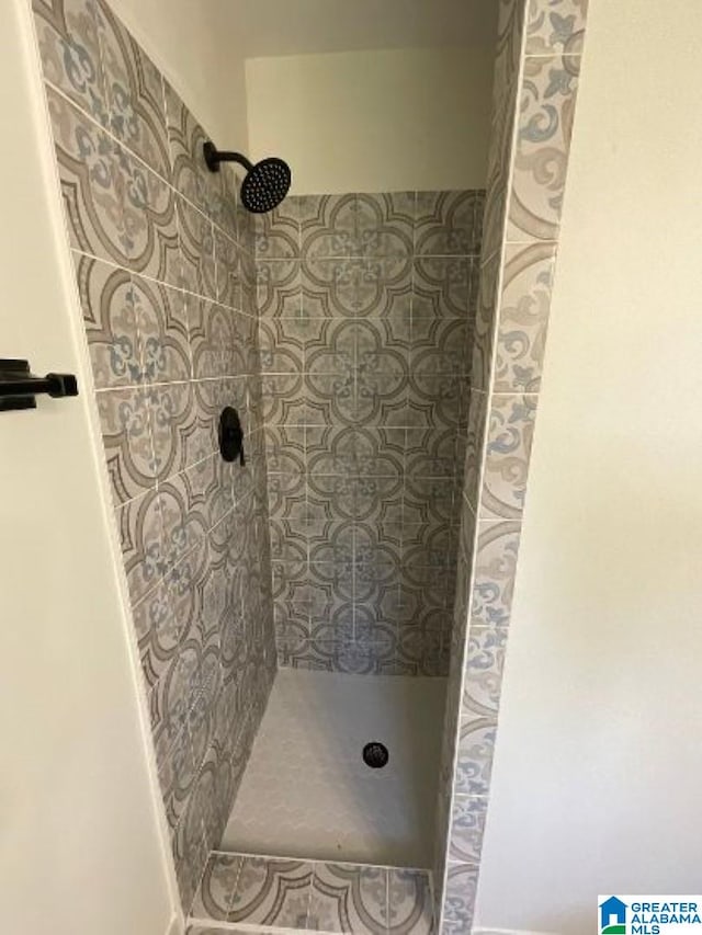 bathroom with a tile shower