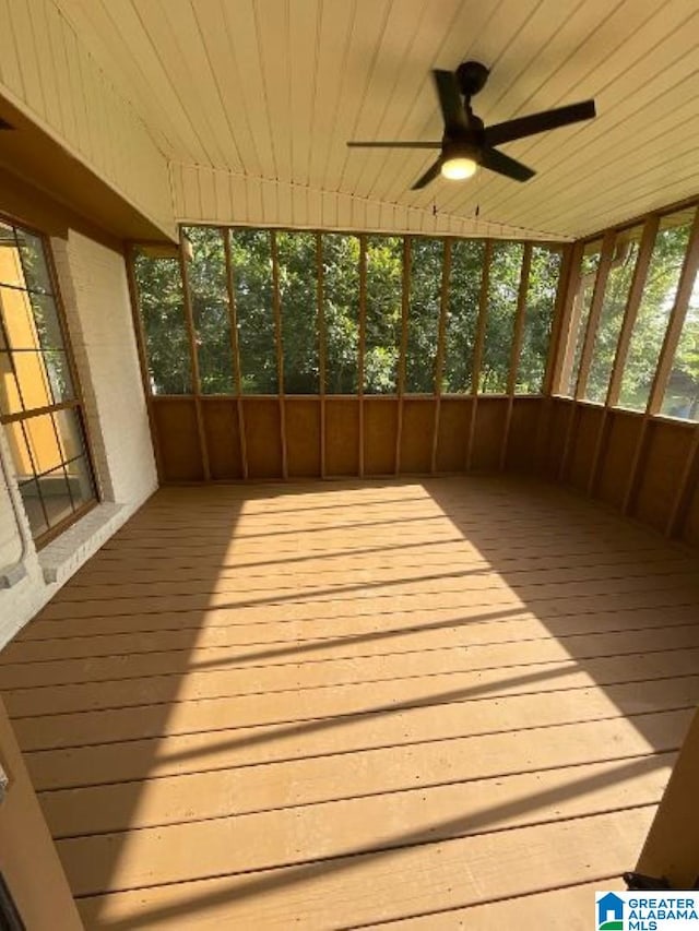 unfurnished sunroom with ceiling fan and a healthy amount of sunlight