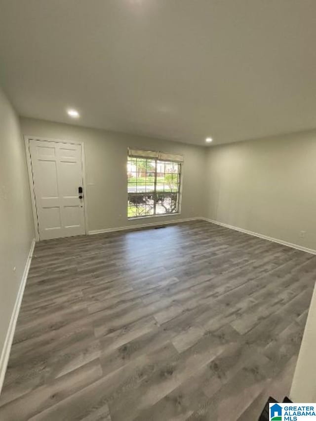 spare room with dark hardwood / wood-style floors