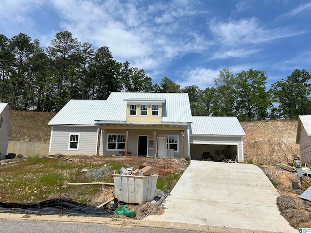 view of front of property featuring covered porch and a garage