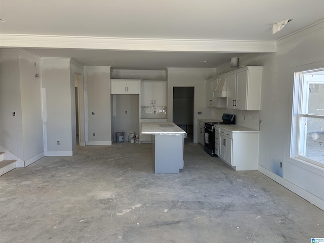 kitchen featuring decorative backsplash, black gas stove, white cabinets, and a wealth of natural light