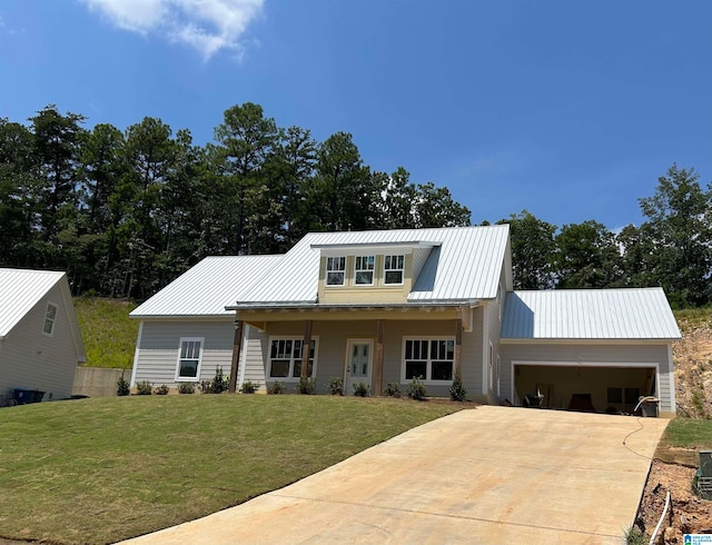 view of front of home featuring a front lawn, a porch, and a garage