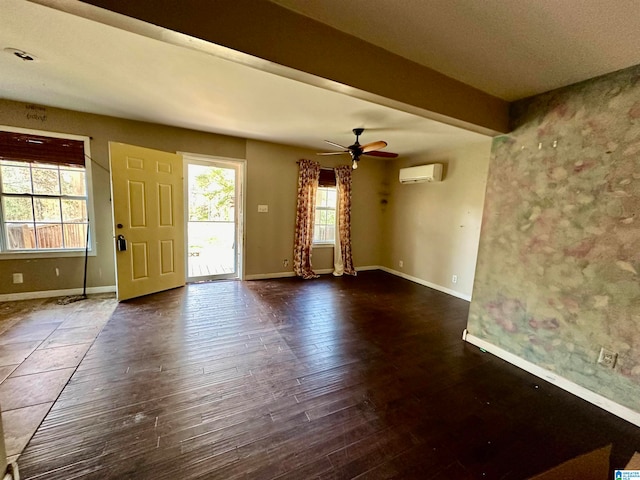 entryway with an AC wall unit, ceiling fan, beam ceiling, and dark hardwood / wood-style floors