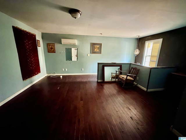 unfurnished room featuring an AC wall unit and dark hardwood / wood-style floors