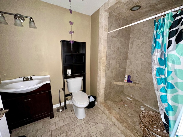 bathroom with toilet, vanity, and a shower with shower curtain