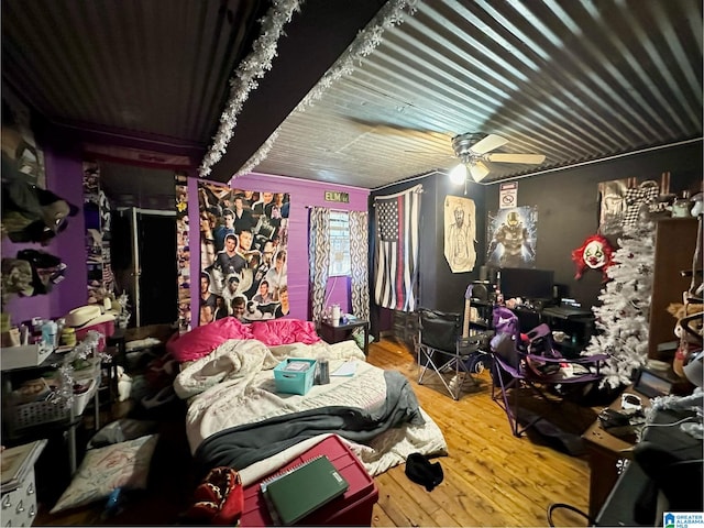 bedroom with ceiling fan and hardwood / wood-style floors