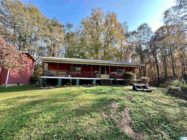 rear view of property with a yard