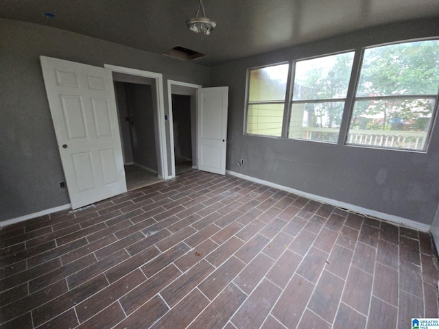 8035 4th Ave S, Birmingham, AL 35206 - unfurnished bedroom featuring baseboards and dark wood-style flooring