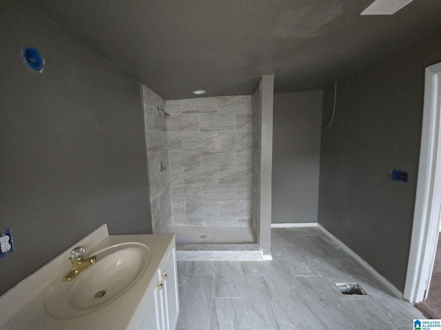 8035 4th Ave S, Birmingham, AL 35206 - bathroom with a tile shower, vanity, and baseboards