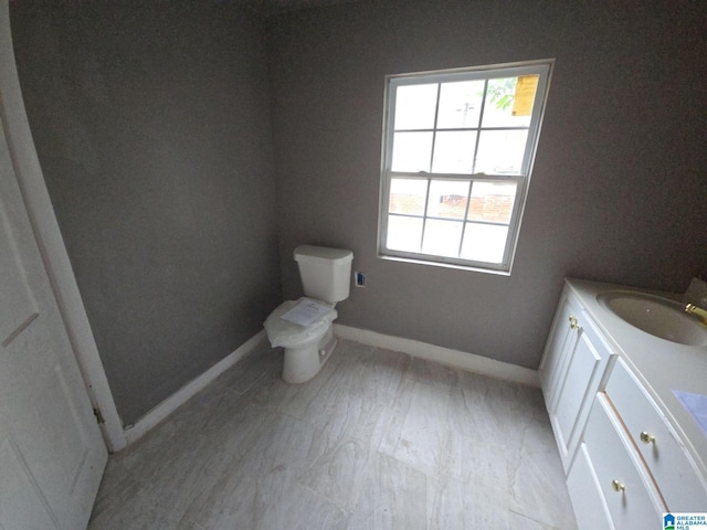 8035 4th Ave S, Birmingham, AL 35206 - bathroom featuring toilet, vanity, plenty of natural light, and baseboards