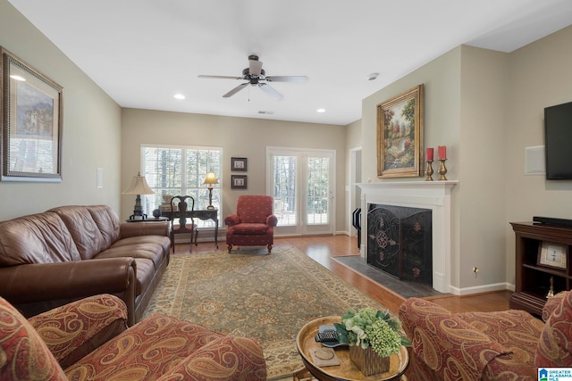 living room featuring ceiling fan and light hardwood / wood-style flooring