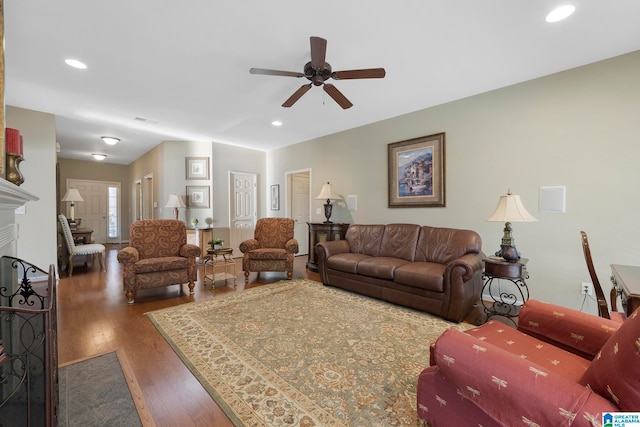 living room with ceiling fan and dark hardwood / wood-style flooring