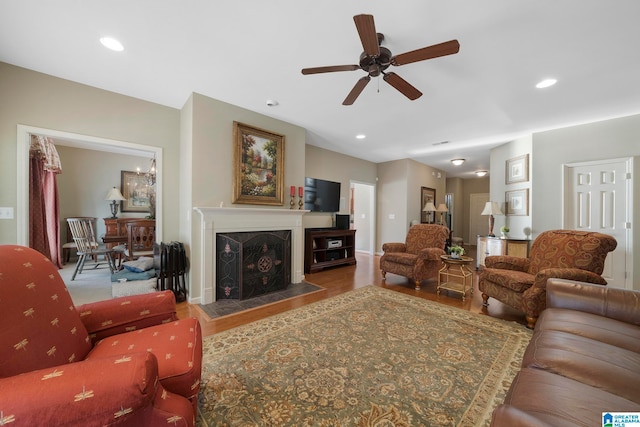 living room featuring ceiling fan and hardwood / wood-style floors