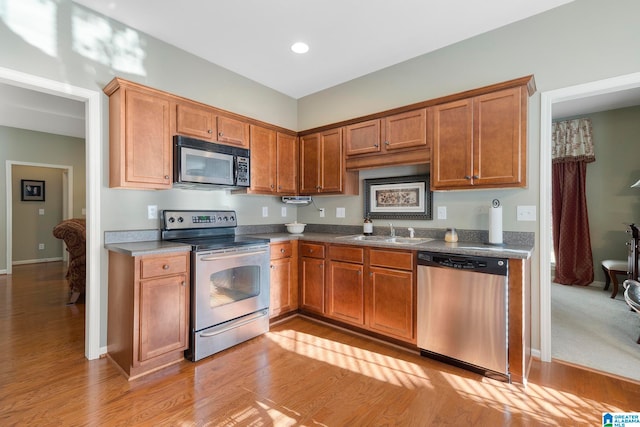 kitchen featuring sink, light wood-type flooring, and stainless steel appliances