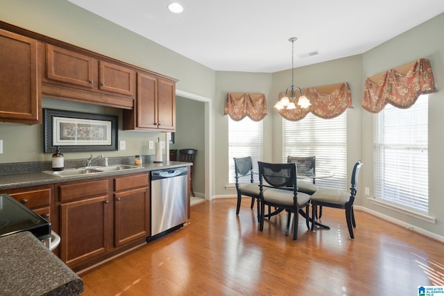 kitchen featuring hardwood / wood-style floors, dishwasher, a healthy amount of sunlight, and a chandelier