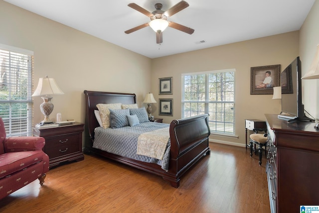 bedroom with ceiling fan and hardwood / wood-style flooring