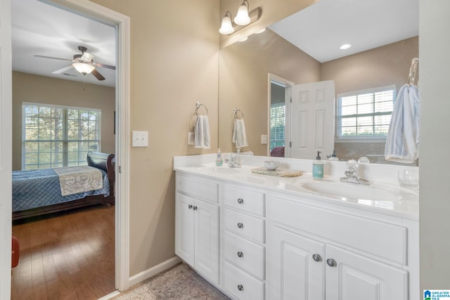 bathroom featuring wood-type flooring, vanity, plenty of natural light, and ceiling fan