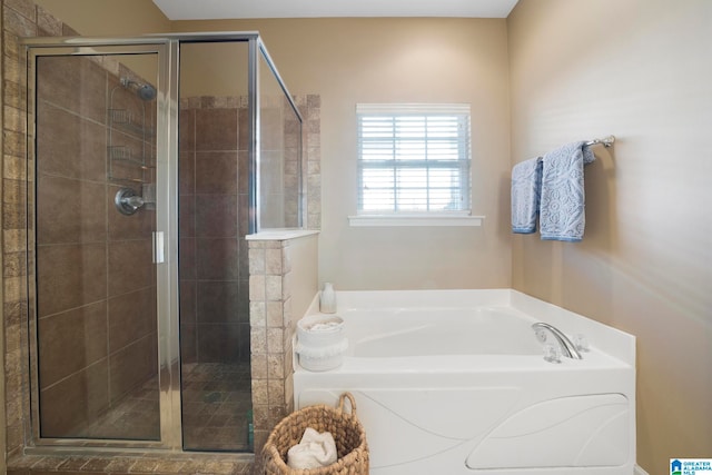 bathroom featuring shower with separate bathtub