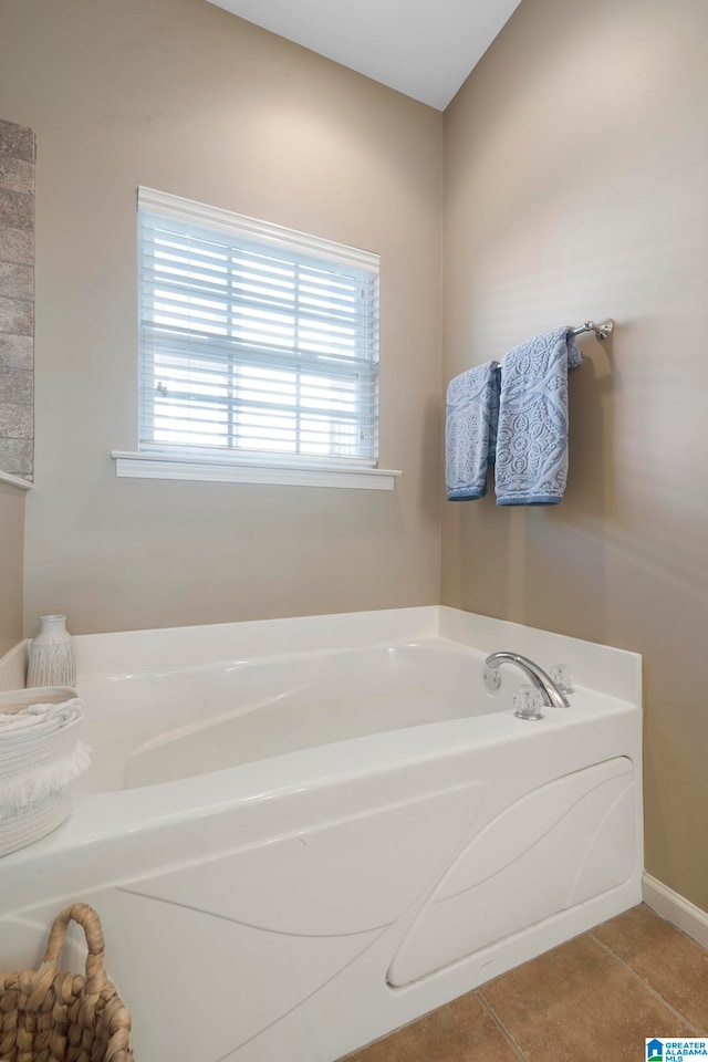 bathroom featuring tile patterned flooring and a bath