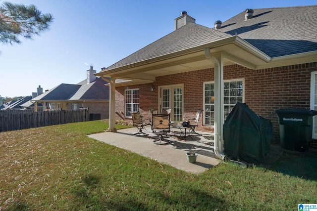 rear view of property with a patio area and a yard