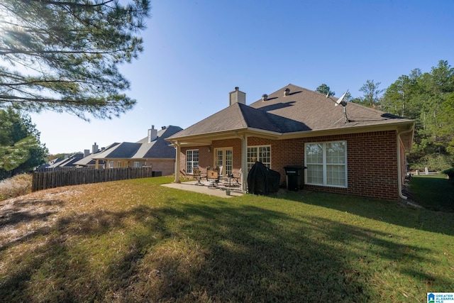 back of house featuring a yard and a patio