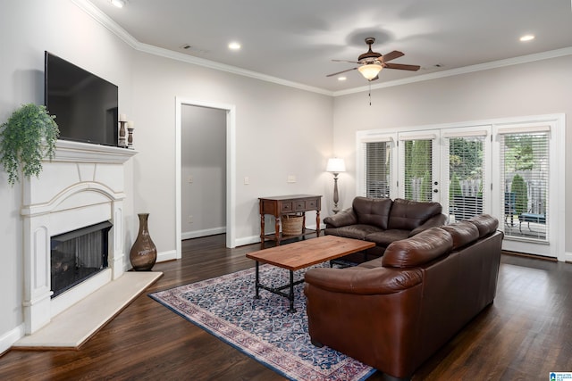 living room with dark hardwood / wood-style floors, ceiling fan, crown molding, and french doors