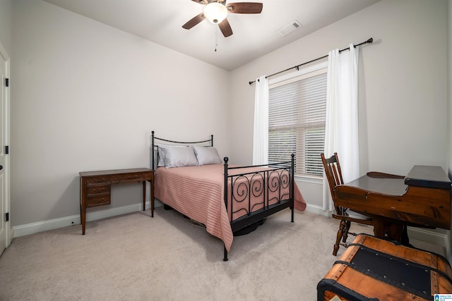 bedroom with ceiling fan and light carpet