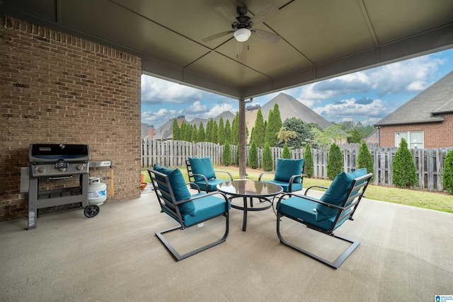 view of patio / terrace with an outdoor living space, area for grilling, and ceiling fan