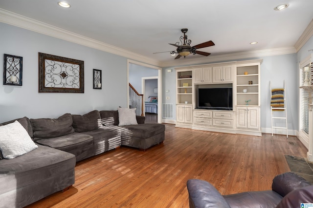 living room with ceiling fan, wood-type flooring, and crown molding