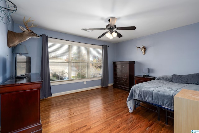 bedroom featuring ceiling fan and dark wood-type flooring