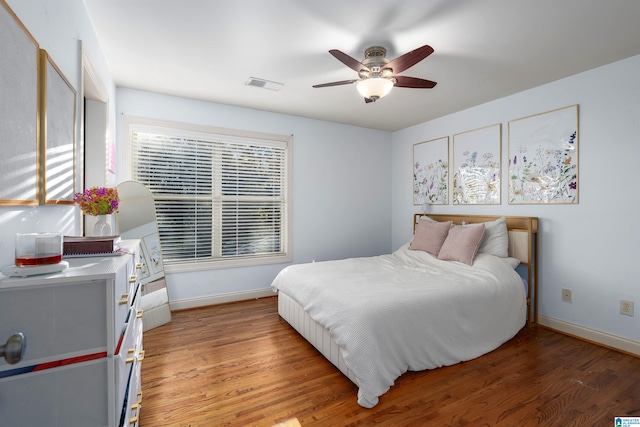 bedroom with hardwood / wood-style floors and ceiling fan