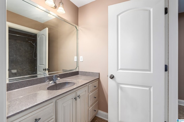 bathroom featuring vanity and a tile shower