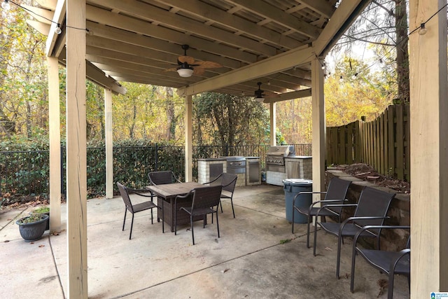 view of patio with area for grilling, ceiling fan, and a grill